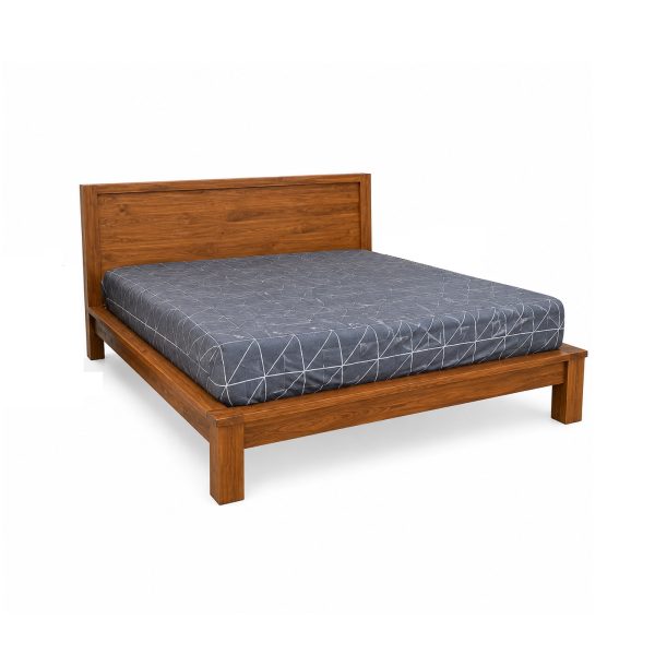 Heritage teak panel bed with natural wood finish and wide wooden headboard